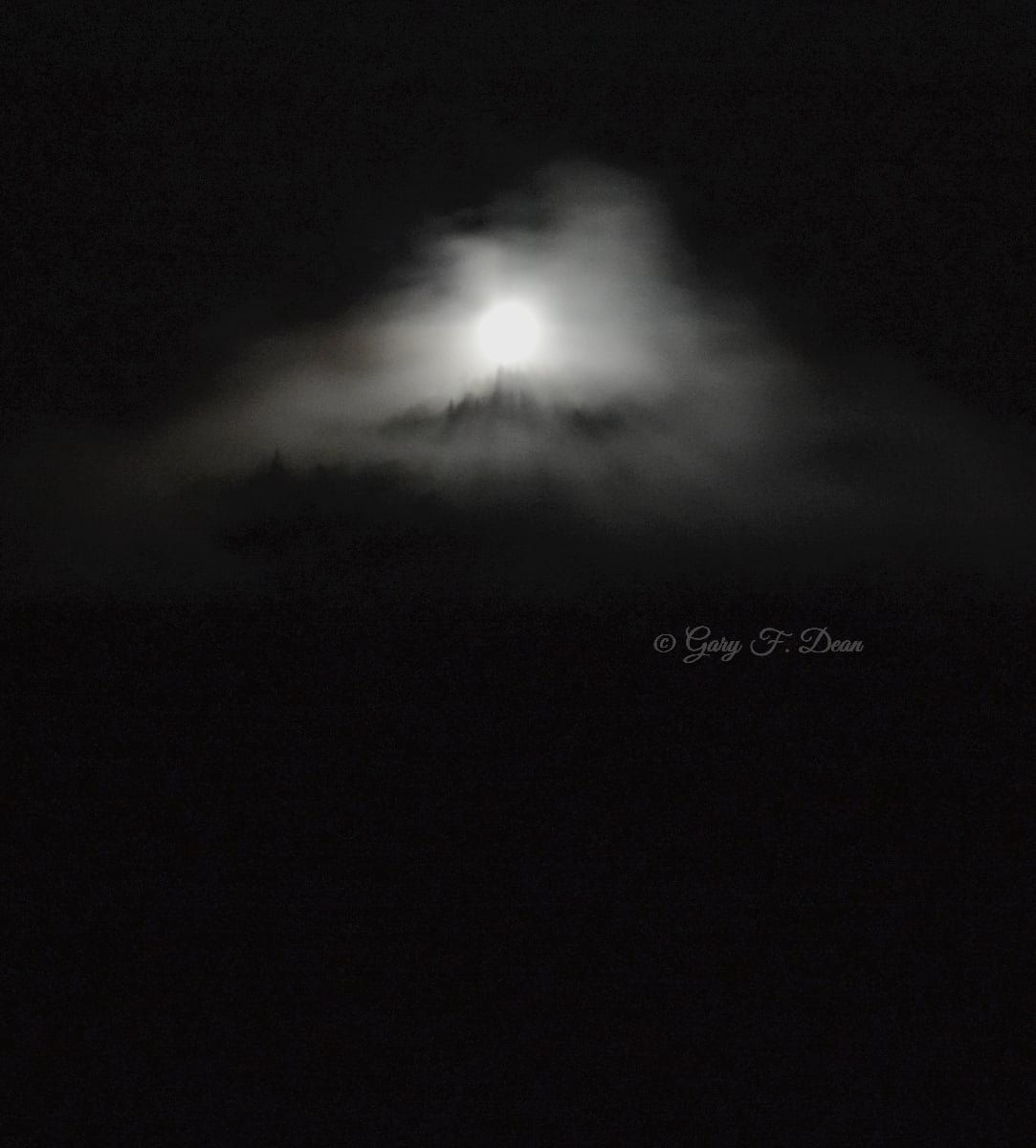 “Labor day weekend, The Fire towers in the Adirondacks are lit for 1/2 hour from 9-9:30pm. I was near St. Regis Mountain north of Tupper Lake, So I took a ride out to capture it. Unfortunately, the sky opened up and the rain made it difficult. But while the Tower was in the clouds, I got some unique images.” Gary Dean