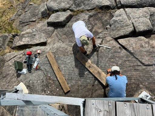 Tom and Bob preparing fence sections for stairway