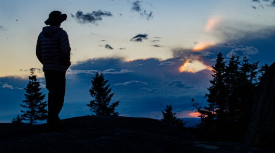 Mark watching the sunset from summit of St Regis Mountain