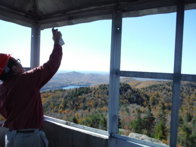 Bob spraying cold galvanization into drilled holes on window frame