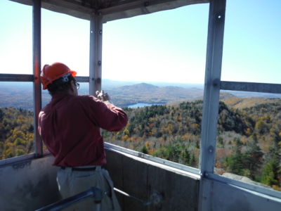 Bob spraying cold galvanization into drilled holes on window frame